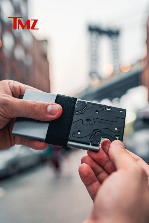 Taking a Pocket Tripod in card form, out of a wallet in Dumbo Brooklyn New York