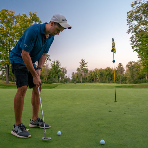 A man ready to swing a golf ball on a golf course