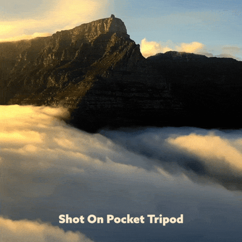 timelapse of clouds flowing over mountain valley during sunset
