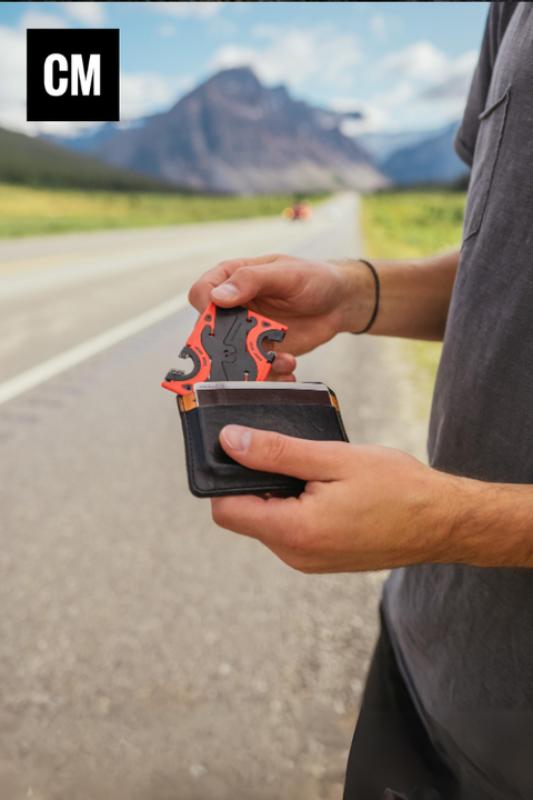 pulling out the card sized pocket tripod from a wallet