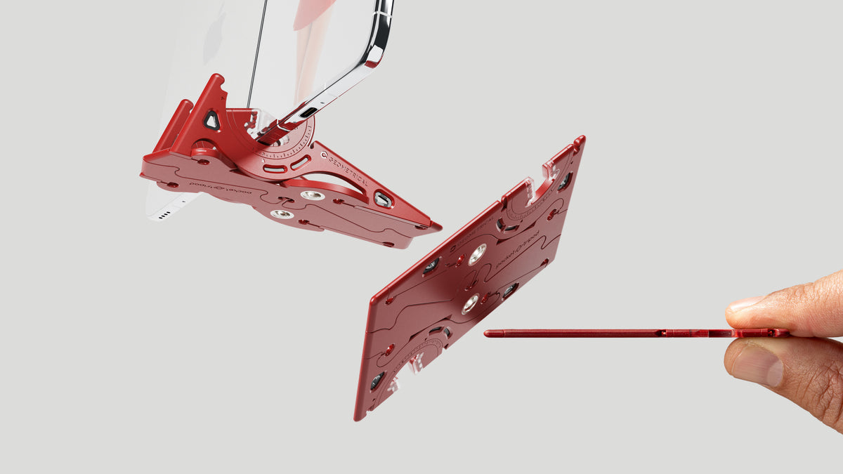 Pocket Tripod PROv2 in Blood Red, deployed and folded, with a hand holding it edge-on