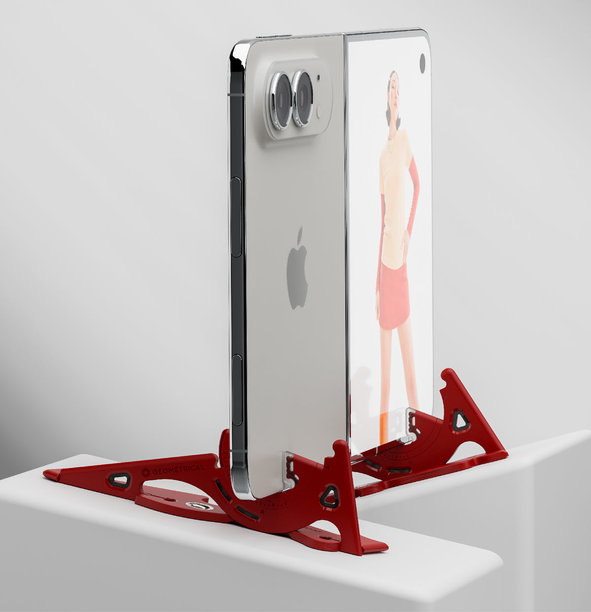 A foldable phone standing upright, each half held by its own red leg