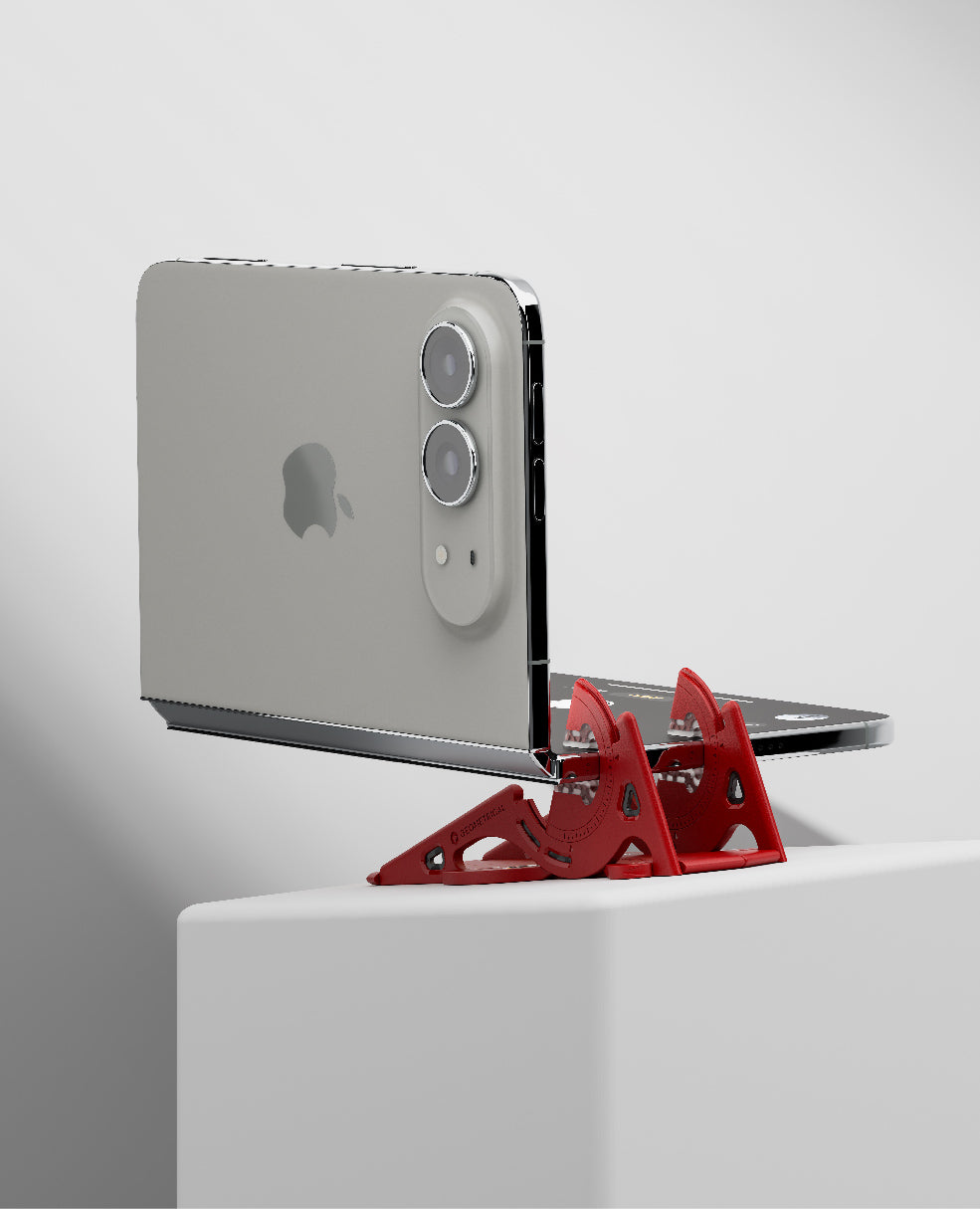A half-folded foldable phone held by its other edge, rear cameras facing forward