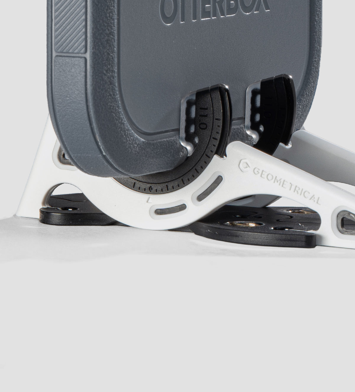 A phone in a rugged OtterBox case held by a Standard Fit Adapter
