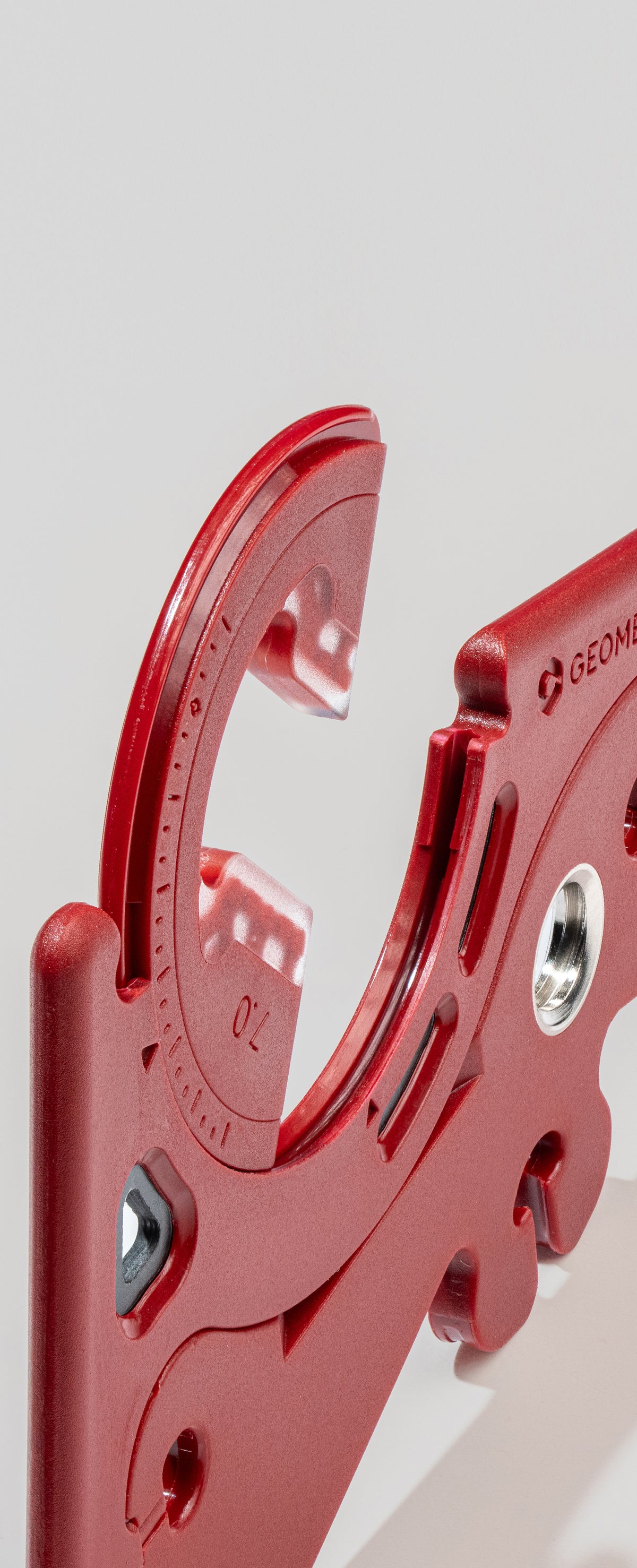 Close-up of the curved rail track and angle markings on a red leg