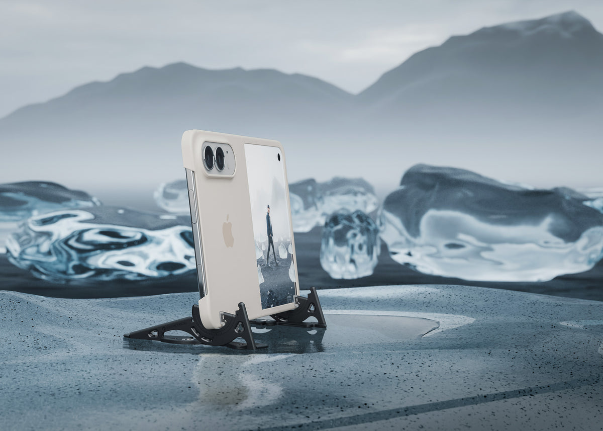 iPhone Duo standing open on a black Pocket Tripod PROv2 on ice, its screen showing a photo, with icebergs and misty mountains behind