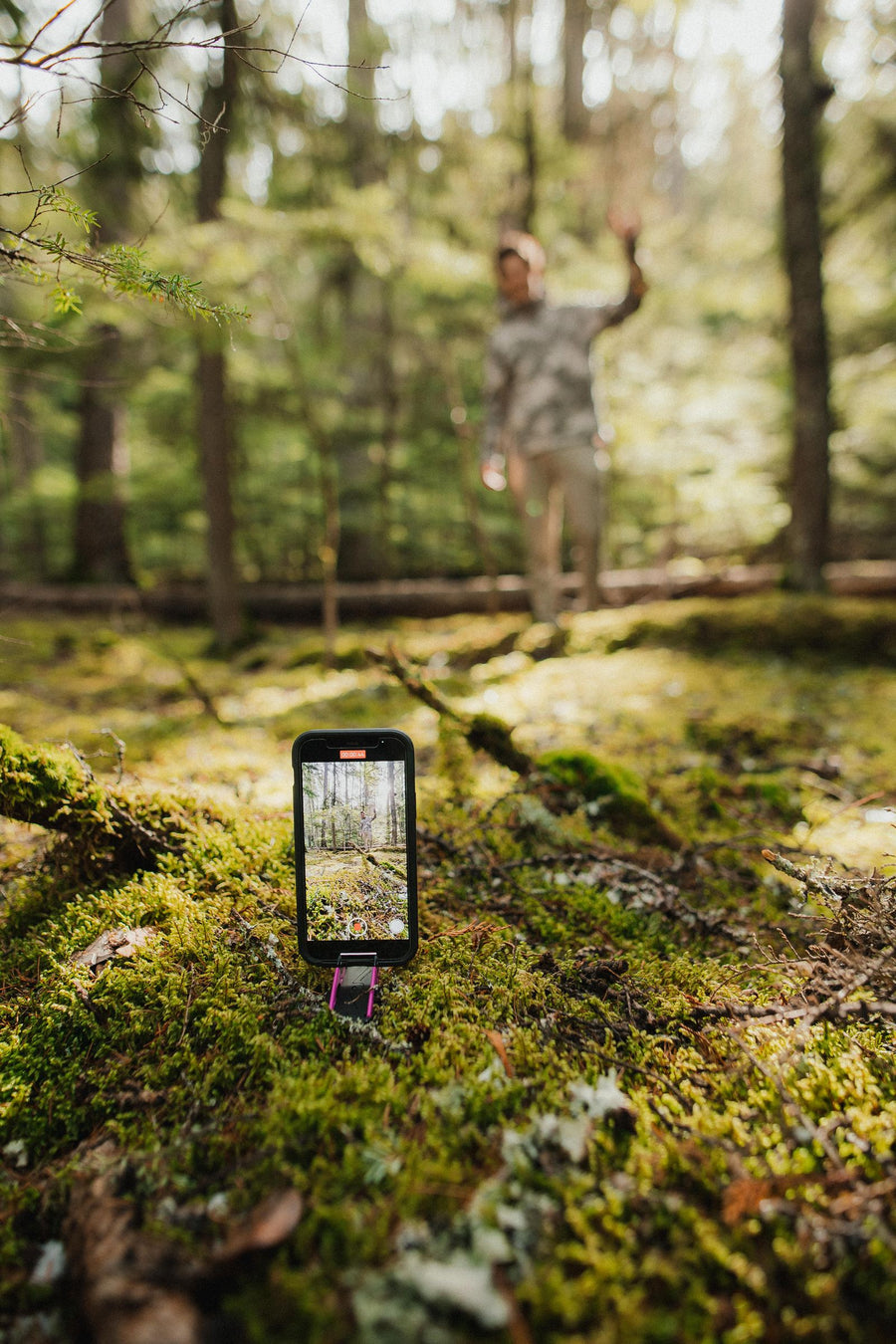 Person mid-jump in a forest