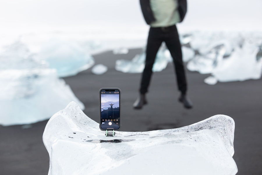 Phone set on ice, person mid-jump