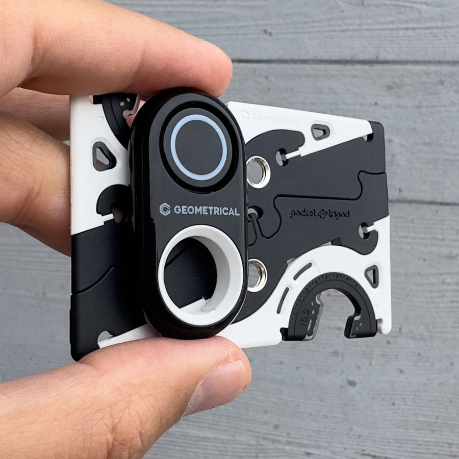 The shutter remote held against the folded Pocket Tripod, showing both are pocket sized