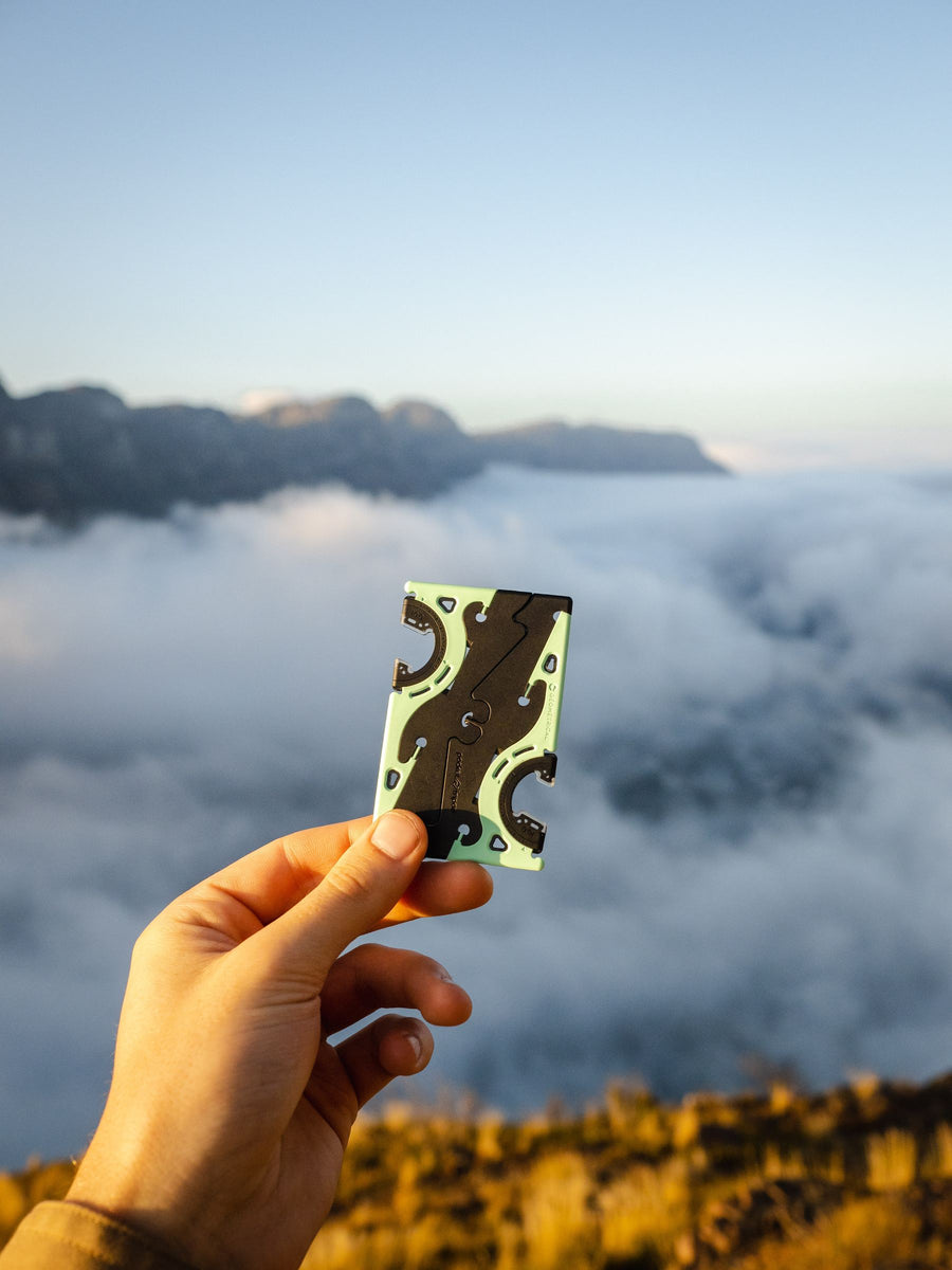 Pocket Tripod in a palm above a sea of cloud