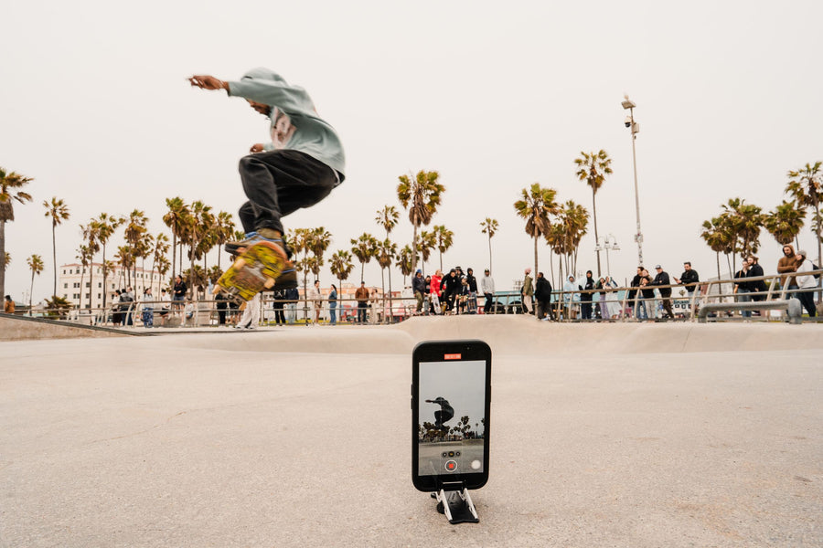 A skater mid-air, camera left standing