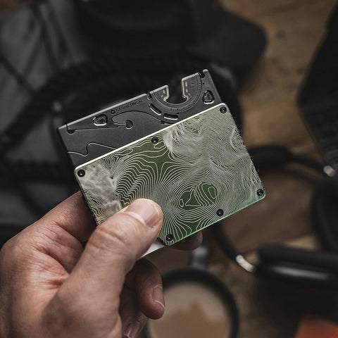 the pocket tripod in card format being inserted into a slim wallet